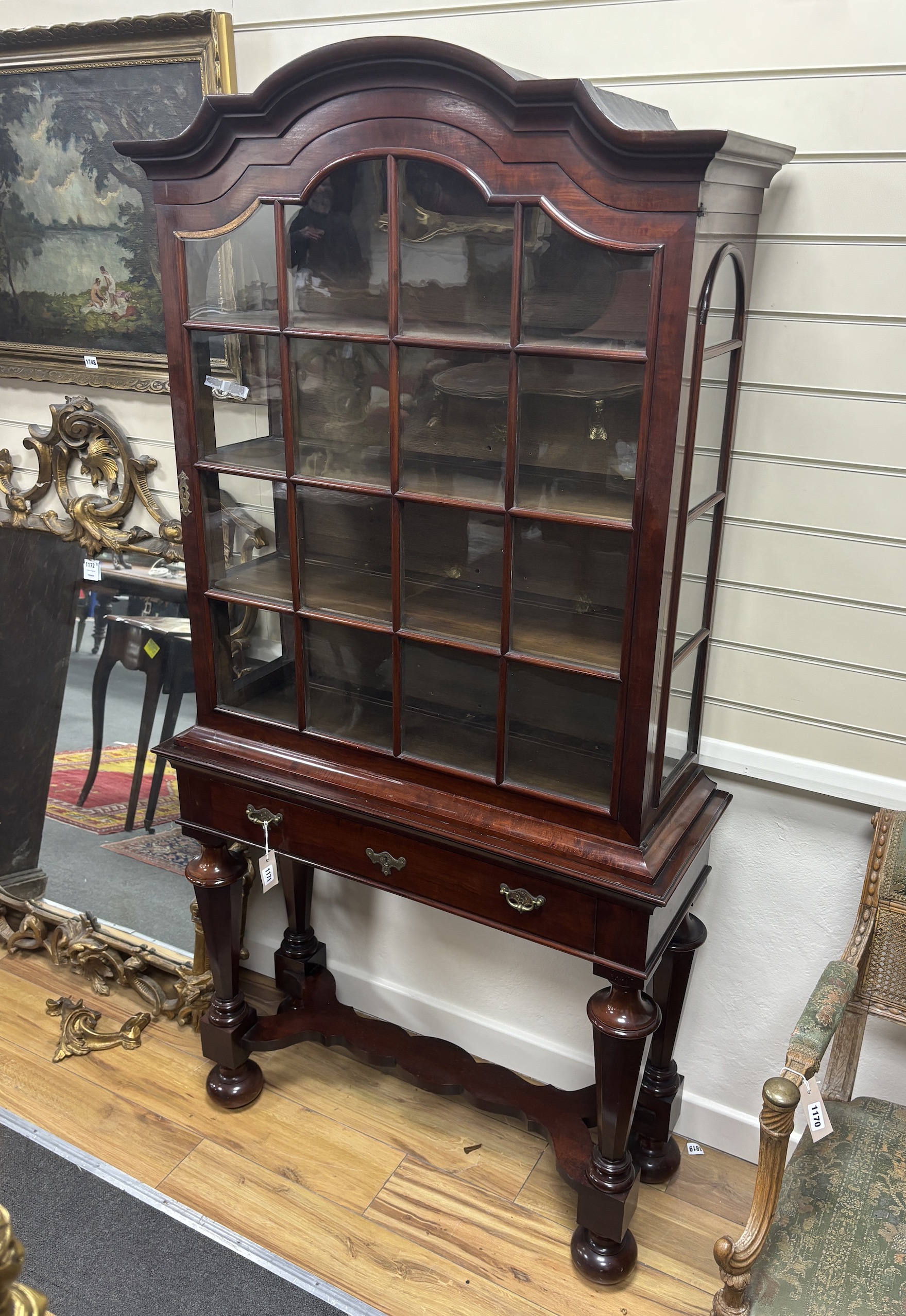 An early 20th century Dutch mahogany display cabinet on stand, width 93cm, depth 35cm, height 187cm